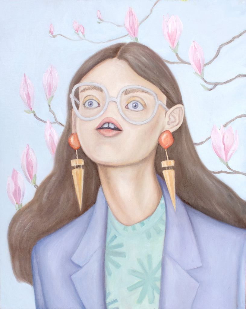 Self portrait of artist Heather Buchanan. She has no nose, but other than that she's doing fine. Pastel purple blazer, statement earrings, long brown hair. There are magnolias blooming in the background.