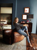 Jennifer Annisten in her home with Horror Scoops horoscopes (torbus and Aquarkiflus)